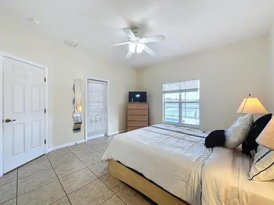 a bedroom with a bed and a ceiling fan at Walk to Silver Spurs Rodeo and Heritage Park in Kissimmee