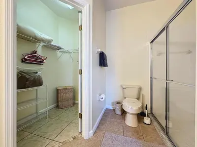 a bathroom with a toilet and a walk in shower at Walk to Silver Spurs Rodeo and Heritage Park in Kissimmee