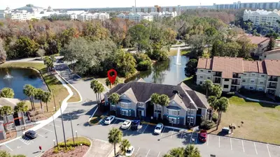 an aerial view of a neighborhood with houses and a river at Parkway Palms Resort 1 bed condo mins to Disney. in Orlando