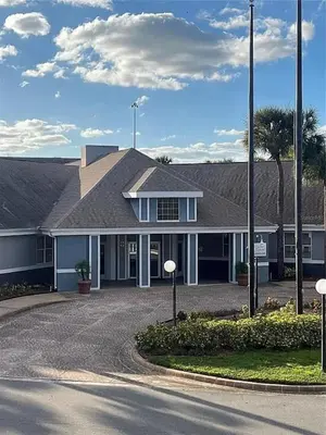 a house with a driveway in front of it at Parkway Palms Resort 1 bed condo mins to Disney. in Orlando