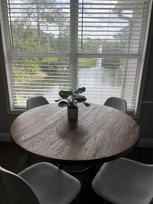 a wooden table with a potted plant in front of a window at Parkway Palms Resort 1 bed condo mins to Disney. in Orlando