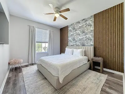a bedroom with a bed and a ceiling fan at Beautiful Three bed condo, Minutes from Disney in Kissimmee