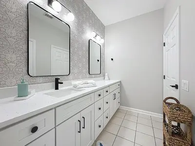 a white bathroom with a sink and a mirror at Beautiful Three bed condo, Minutes from Disney in Kissimmee