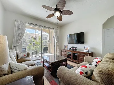 a living room with two couches and a flat screen tv at Magical 3BR/2BA Disney-Themed Condo in Orlando