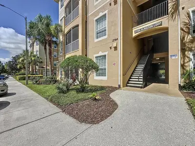 a sidewalk in front of a building with a staircase at Magical 3BR/2BA Disney-Themed Condo in Orlando