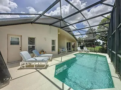 a swimming pool with chairs and a glass ceiling at Emerald Island 4Bd/3Ba Villa, 3 miles to Disney in Kissimmee