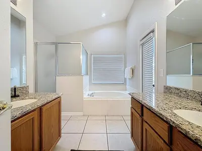a bathroom with two sinks and a bath tub at Casa del Sol at Indian Creek Four Corners in Kissimmee