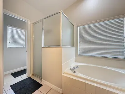 a bathroom with a tub and a window at Casa del Sol at Indian Creek Four Corners in Kissimmee