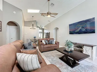 a living room with a couch and a table at Casa del Sol at Indian Creek Four Corners in Kissimmee