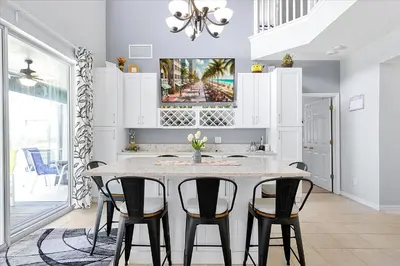 a kitchen with a table and four chairs at Emerald Island Resort 6 Bed Pool & Spa in Kissimmee