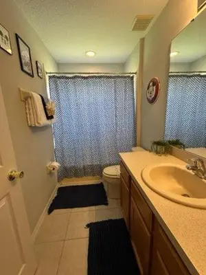 a bathroom with a sink and a toilet and a shower at Emerald Island Resort 6 Bed Pool & Spa in Kissimmee