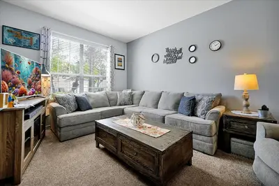 a living room with a couch and a tv at Emerald Island Resort 6 Bed Pool & Spa in Kissimmee