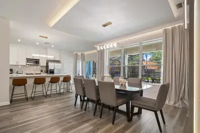 a kitchen and dining room with a table and chairs at 2540HS 6Bedrooms Disney Villa Sleeps 20 with Pool & Spa in Orlando