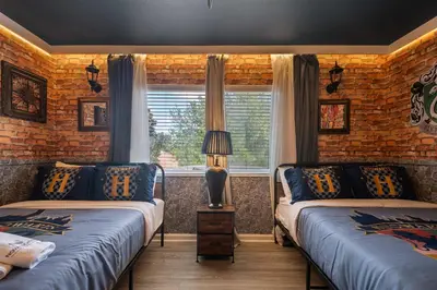 a bedroom with two beds and a window at 2540HS 6Bedrooms Disney Villa Sleeps 20 with Pool & Spa in Orlando