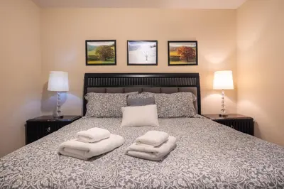 a bedroom with a bed with two white towels on it at Vista Cay Townhome Near Universal & Disney in Orlando
