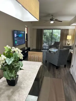 a living room with a couch and a dining room at Central Location to all Parks and Convention center in Orlando