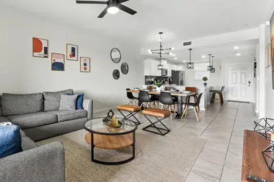 a living room with a couch and a table at Elegant 2BR in Storey Lake Top Location in Kissimmee