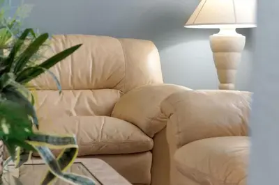 a brown leather chair sitting next to a lamp at Ever After Estate in Kissimmee