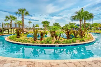 a pool at a resort with palm trees at Storey Lake condos by Une Homes in Kissimmee