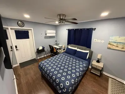 a bedroom with a bed and a ceiling fan at Signature Suite in Orlando