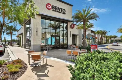 a building with chairs and tables in front of it at The Flamingo Nest - Kid Friendly in Orlando