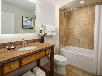 a bathroom with a sink and a toilet and a tub at Sheraton Vistana Villages 1BR Apartment with Resort Access in Orlando