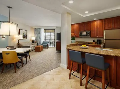 a kitchen and living room with a table and chairs at Sheraton Vistana Villages 1BR Apartment with Resort Access in Orlando
