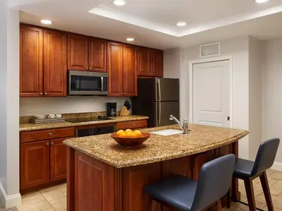 a kitchen with a bowl of fruit on a counter at Sheraton Vistana Villages 1BR Apartment with Resort Access in Orlando