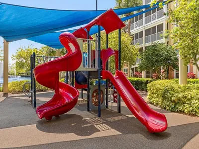 a playground with a red slide in a park at Sheraton Vistana Villages 1BR Apartment with Resort Access in Orlando