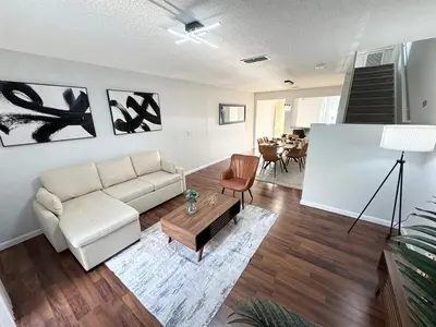 a living room with a couch and a table at 2BR Villa Near Disney, Gated community with Pool in Kissimmee