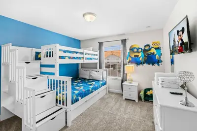 a bedroom with white bunk beds and a blue wall at Casa Familiar no Storey Lake c/ Piscina in Kissimmee
