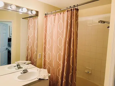 a bathroom with a sink and a shower at The Orlando Hideaway Family Townhome Steps from Disney 3BR 3BA in Kissimmee