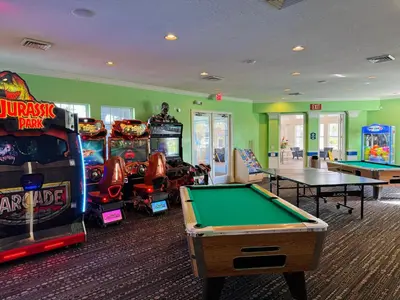 a gaming room with arcade games and pool tables at The Orlando Hideaway Family Townhome Steps from Disney 3BR 3BA in Kissimmee