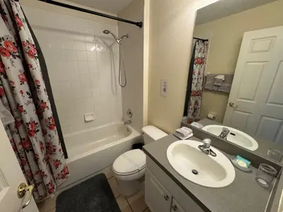 a bathroom with a sink and a toilet and a shower at Casablanca Villa home in Kissimmee