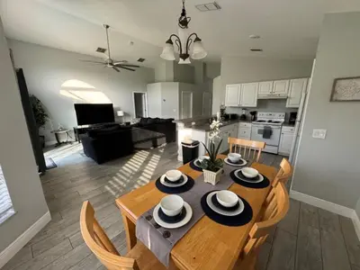 a kitchen and dining room with a table and chairs at Casablanca Villa home in Kissimmee