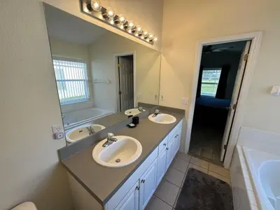 a bathroom with two sinks and a large mirror at Casablanca Villa home in Kissimmee