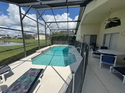 a view of a swimming pool on a patio at Cumbrian Sunset Villa home in Kissimmee