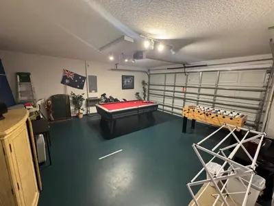 a room with a pool table in a garage at Cumbrian Sunset Villa home in Kissimmee