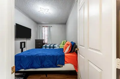 a bedroom with a bed and a flat screen tv at Royal Homes in Kissimmee