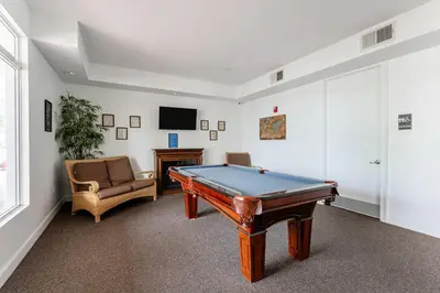 a living room with a pool table and a couch at Royal Homes in Kissimmee