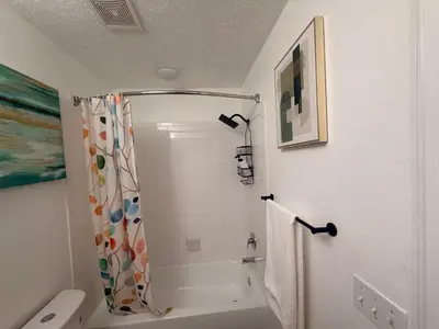 a bathroom with a shower curtain and a toilet at Royal Homes in Kissimmee