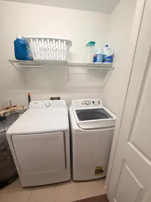 a kitchen with a stove and a washing machine at Royal Homes in Kissimmee