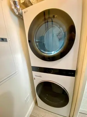 a washer and dryer in a kitchen next to a door at Wands & Wishes | Luxury Condo Minutes from Disney in Orlando