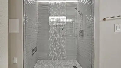 a bathroom with a shower with a glass door at Wands & Wishes | Luxury Condo Minutes from Disney in Orlando