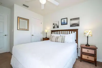 a bedroom with a white bed and two lamps on a night stand at Bright 3B w Pool Close to Disney Encantada 8545 in Kissimmee