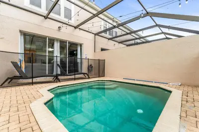 a swimming pool in a house with a glass ceiling at Magical Stay Near Disney I Pool and Resort Access in Kissimmee