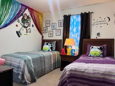 a bedroom with two beds with stuffed animals on them at Toy Story Getaway Retreat in Kissimmee