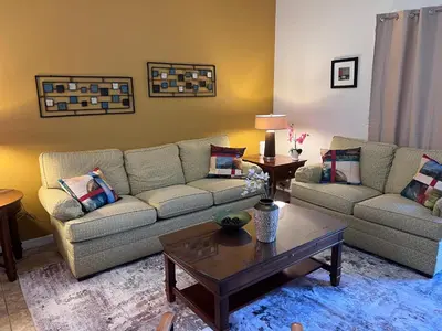 a living room with two couches and a coffee table at Toy Story Getaway Retreat in Kissimmee