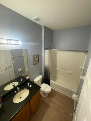 a bathroom with a sink and a toilet and a mirror at Casa Bella Vida Resort Kissimmee in Kissimmee