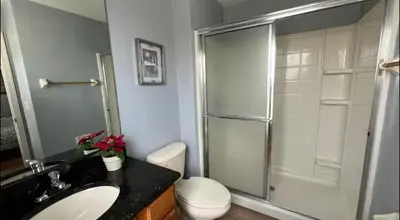 a bathroom with a shower and a toilet and a sink at Casa Bella Vida Resort Kissimmee in Kissimmee
